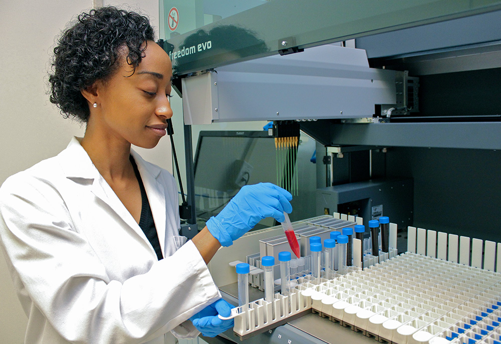 female technician work with samples near a fume hood