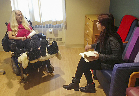 womann in wheelchair talking to another woman in a consultation room