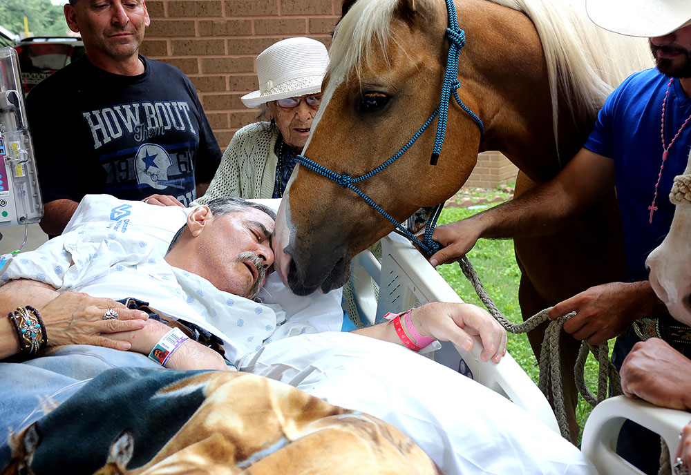 Image of Veteran outdoors with friends and his horse