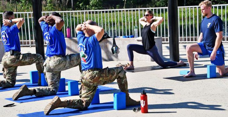 Veterans participating in a yoga class led by two instructors