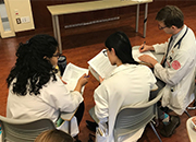 Three health professions trainees studying