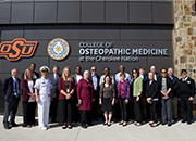 Members of VA’s National Academic Affiliations Council pose for a photo outside the Oklahoma State University’s College of Osteopathic Medicine at the Cherokee Nation, Sept. 28, 2023.