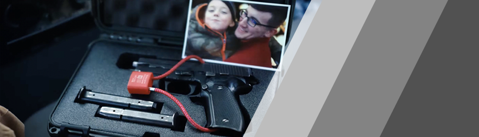 Photo of father and son along with securing gun in lockbox.