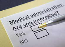 A photo of a pen checking yes on a questionnaire asking Are you interested in medical administration?  