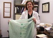 Foodservice dietician, Annemarie Price, MS, RD, shows why the Martinsburg VA Medical Center has an award-winning composting program as she prepares to collect organic waste to compost in a bio bag.
