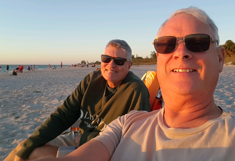 Veteran and Husband on beach.