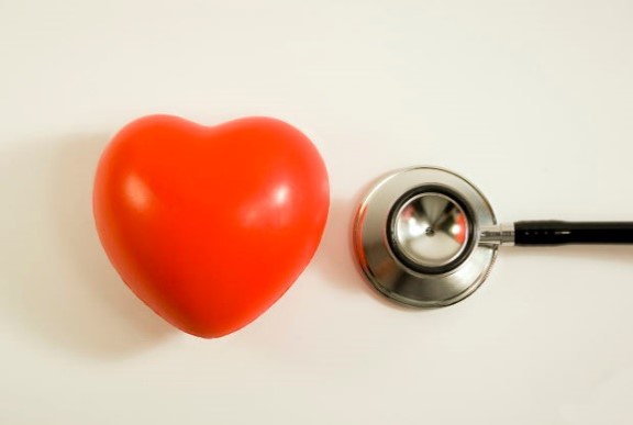 A heart shaped stress squeeze cushion and a stethoscope.