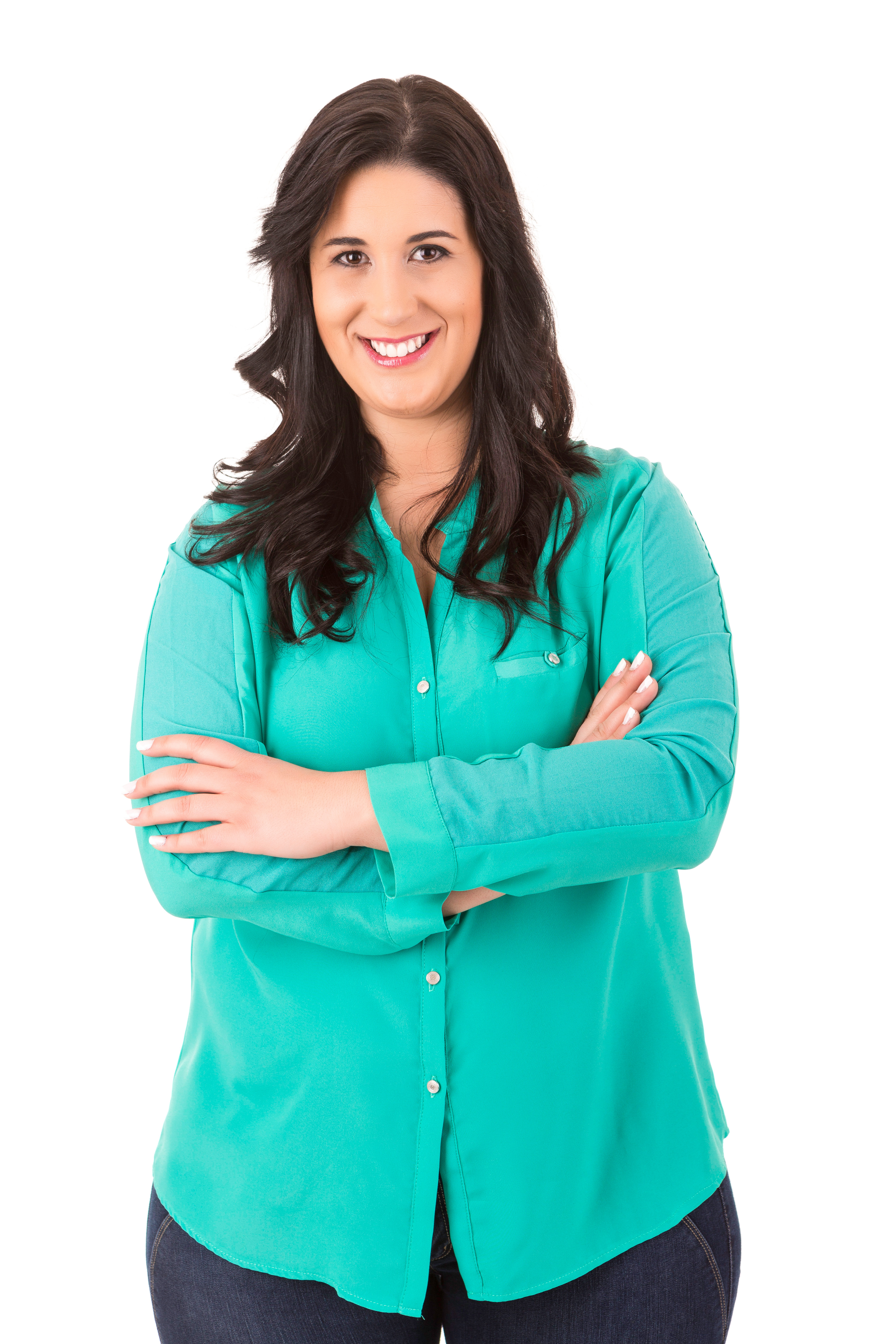 Smiling woman in teal long-sleeve button-down shirt with arms crossed.