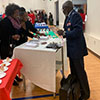 Dennis May mans an outreach table and provides VA Benefits books and other VA material at the MZBC Veterans Day event...in his Air Force uniform! Aim High, Colonel May!