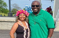 Minority Veteran Program Coordinator for VBA Brent Williams by the stage in Mount Trashmore, Virginia Beach during Asian Fest 2022 with event organizer Tricia Orpillia