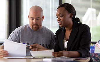 woman helping a man with documents