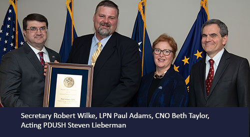 Paul Adams receives award from Secretary Wilke