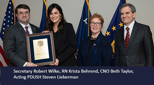 Krista Behrend receives award from Secretary Wilke