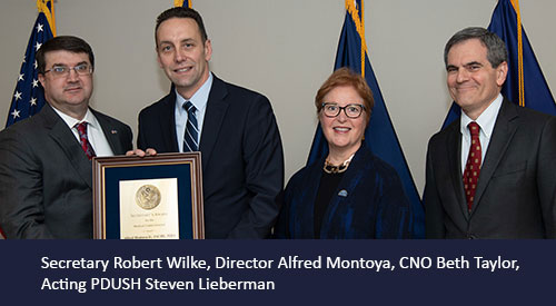 Alfred Montoya receives award from Secretary Wilke