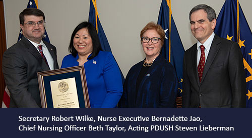 Bernadette Ja receives award from Secretary Wilke