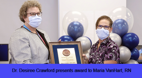 Dr. Desiree Crawford presents award to Maria VanHart, RN