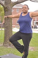 Female Veteran practicing yoga outside VA