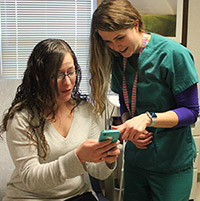 VA nurse showing Annie App to Veteran