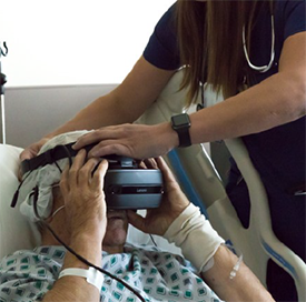 nurse helping patient with virtual realiaty mask