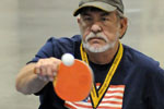 A Veteran returns a serve during table tennis match.