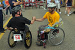 Two wheelchair athletes congratulate each other following the slalom race.