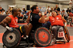 A group of athletes compteting in quad rugby.