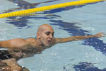 A male athlete swimming in the pool.