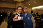 Two male veterans holding up an event identification card.