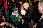 Vice President Joe Biden greeting veterans and shaking the hand of a man in a wheelchair.
