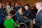Vice President Joe Biden greeting veterans and speaking with a man in a wheelchair.