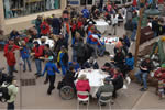 A large crowd of people eating lunch in the open air courtyard at Snowmass Village.