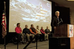 Special guests on a stage listen to Vice President Joe Biden speak at the Closign ceremonies of the 2011 National Disabled Veterans Winter Sports Clinic.