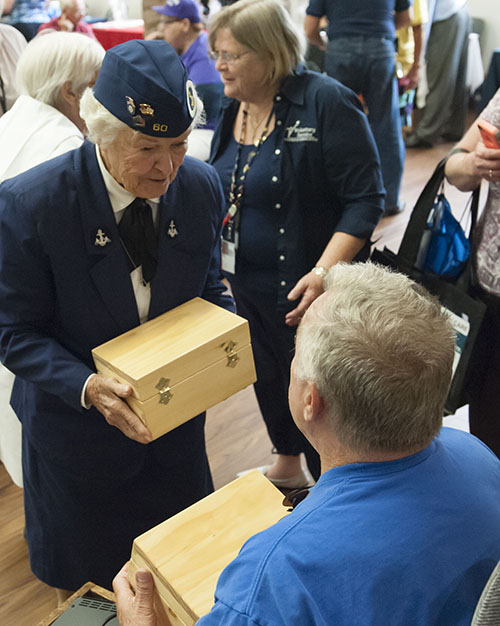 Ms. Vivian Cunningham is being presented a handmade music box from one of our male Veterans.