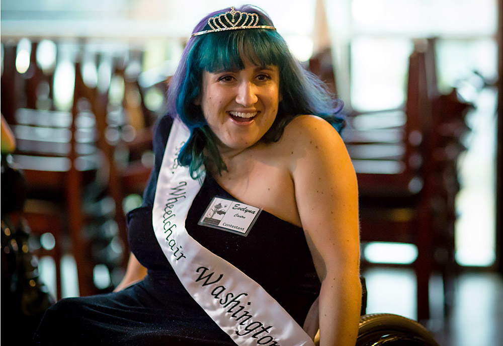 A woman with a crown in a wheelchair smiles A woman with a crown in a wheelchair smiles