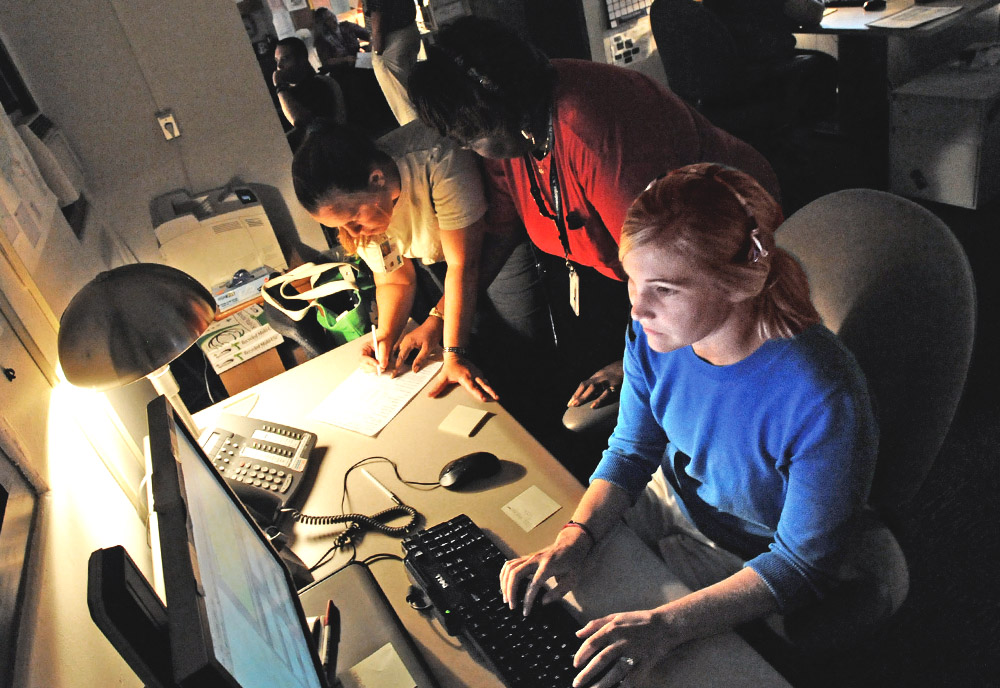 Responders work on a call in a call center Responders work on a call in a call center
