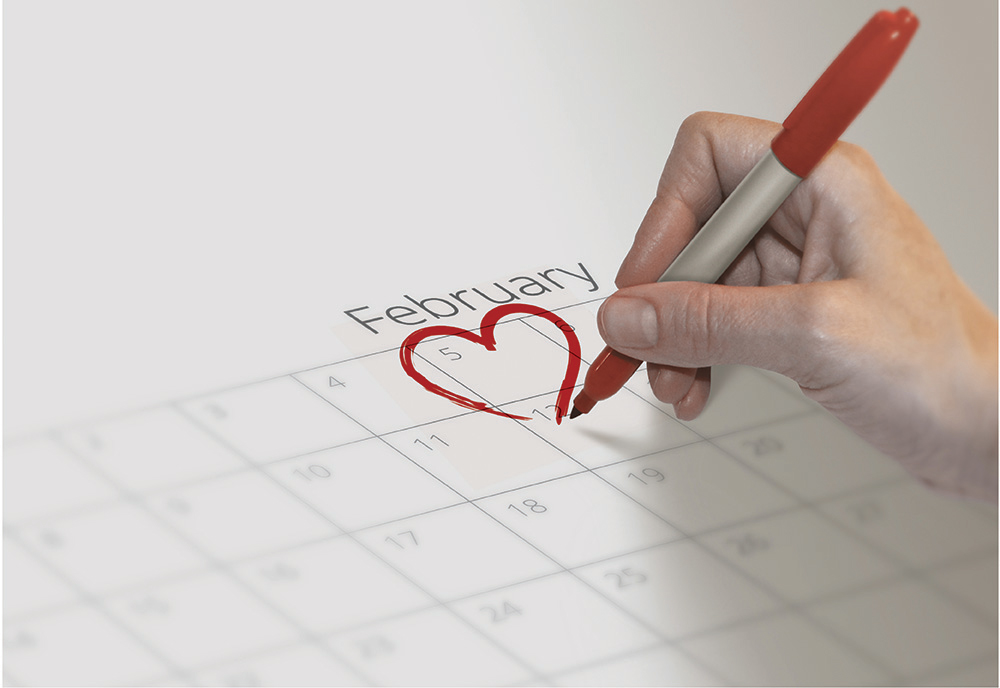 A woman marking the calendar in February, for Heart Health Month A woman marking the calendar in February, for Heart Health Month