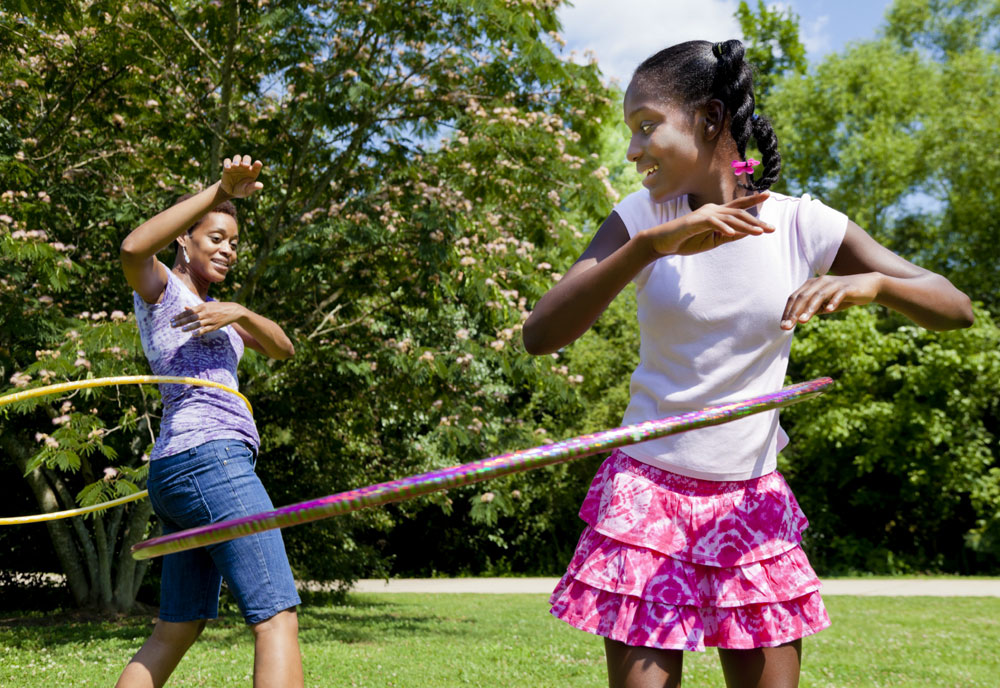mother and daughter using hula hoops mother and daughter using hula hoops