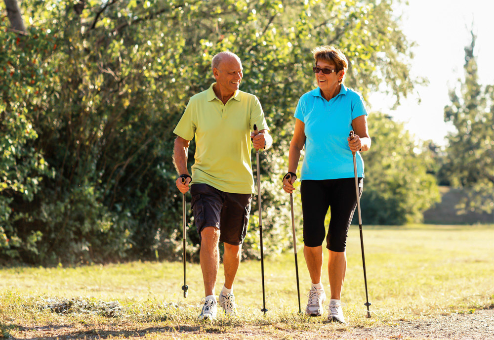 Two people walking with nordic walking sticks Two people walking with nordic walking sticks