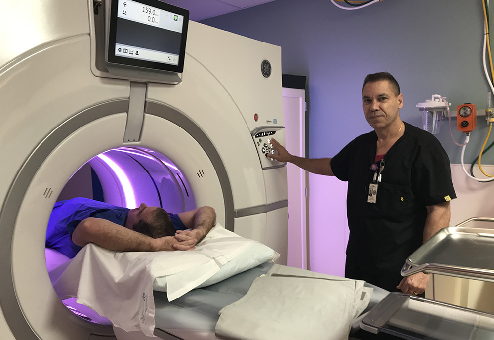 U.S. Army Veteran Jim Altman receives lung cancer screening facilitated by CT Technologist, Miguel Santiago at the C.W. Bill Young VA Medical Center. U.S. Army Veteran Jim Altman receives lung cancer screening facilitated by CT Technologist, Miguel Santiago at the C.W. Bill Young VA Medical Center.
