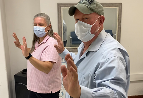 Recreation Therapist leads a Veteran through Tai Chi exercise. Recreation Therapist leads a Veteran through Tai Chi exercise.