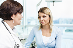 A female doctor speaks with a female patient