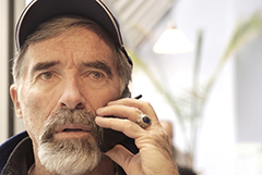 A man speaks into a mobile phone